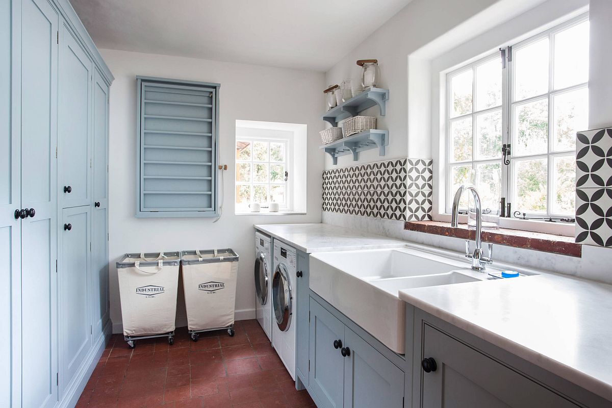 large laundry room with farmhouse sink and black and white tiled backsplash