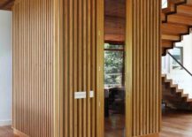 Wooden-structure-creates-a-room-within-a-room-inside-the-spacious-Brazilian-house-217x155
