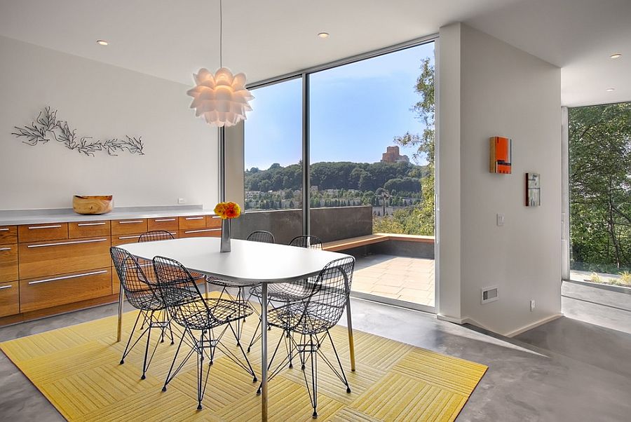 Yellow rug in the dining room feels apt in this contemporary dining room despite its bright color