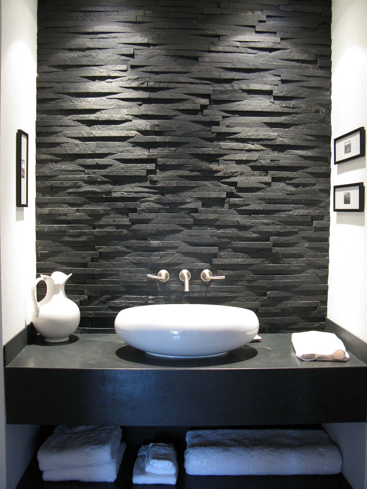 Black-slate-is-used-to-shape-both-the-backsplash-and-the-vanity-in-this-small-modern-bathroom