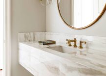 Brass-fixtures-add-metallic-glitter-to-the-custom-stone-vanity-in-the-sophisticated-bathroom-217x155