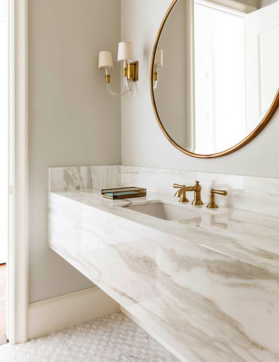 Brass-fixtures-add-metallic-glitter-to-the-custom-stone-vanity-in-the-sophisticated-bathroom