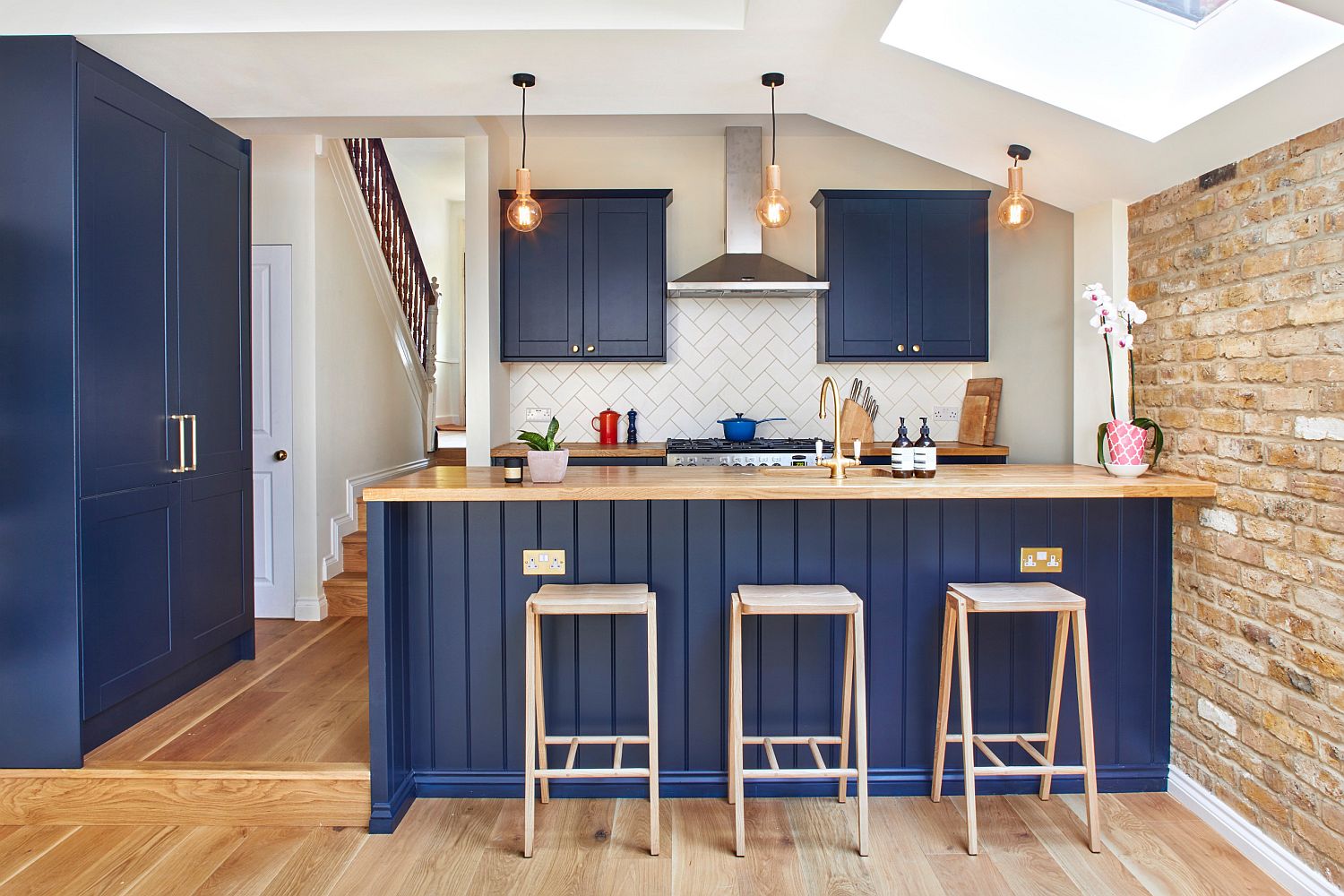 Brick wall, skylight and a splash of blue for the delightful modern kitchen