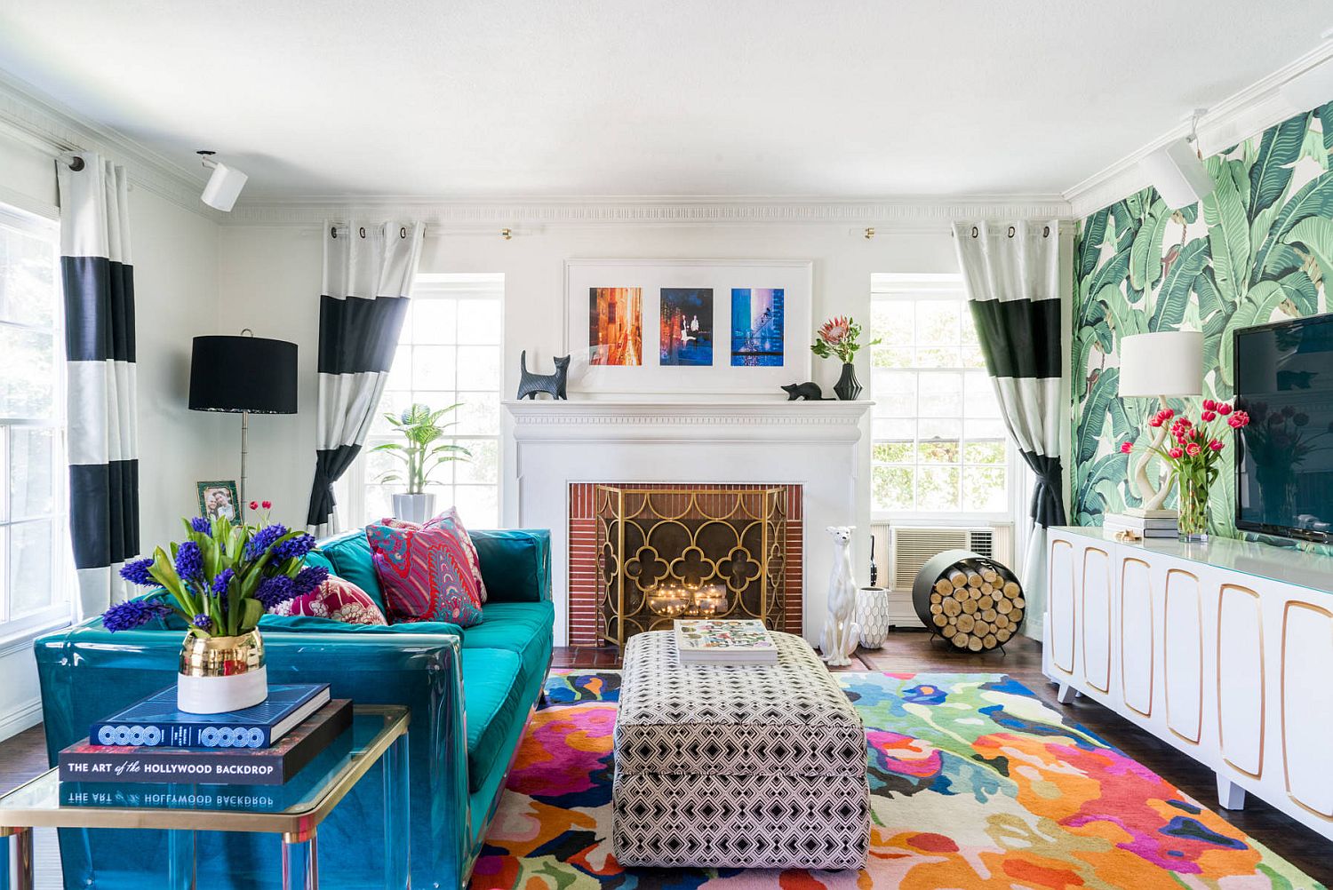 Brilliant blue couch and multi-colored rug for the small tropical style living space