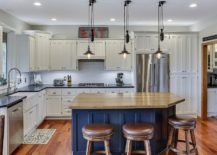 Cabinets-draped-in-white-enamel-coupled-with-bright-blue-island-in-the-kitchen-217x155