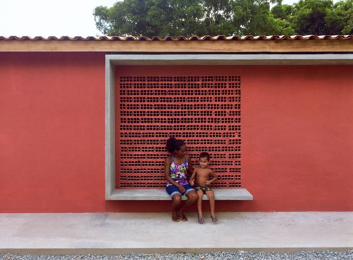 Ceramic bricks and reddish hue create a cool building that serves multiple tasks