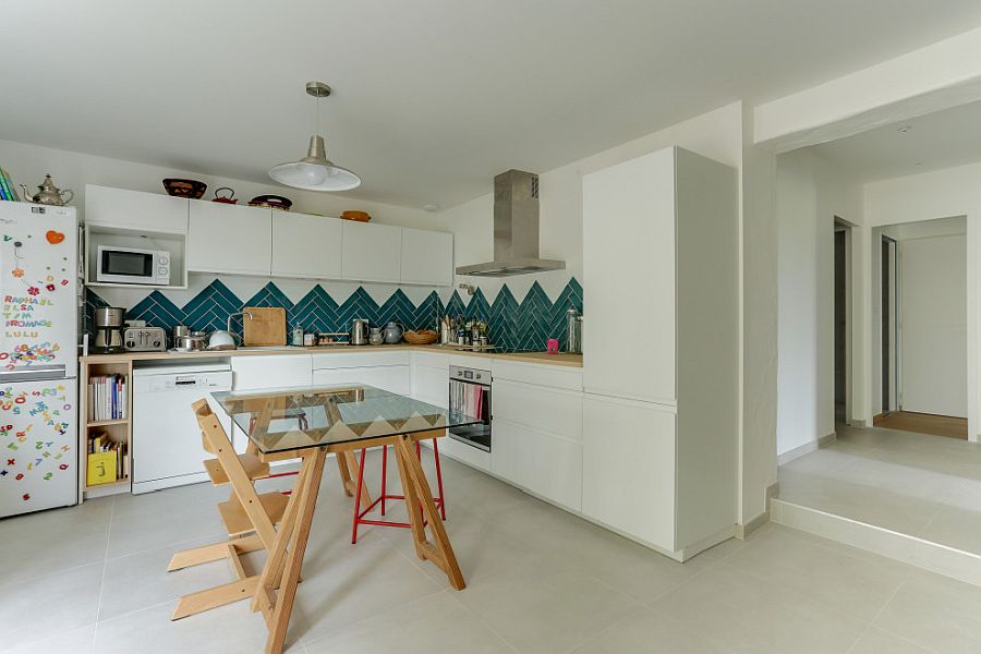 Chevron pattern dark green tiled backsplash for the kitchen in white