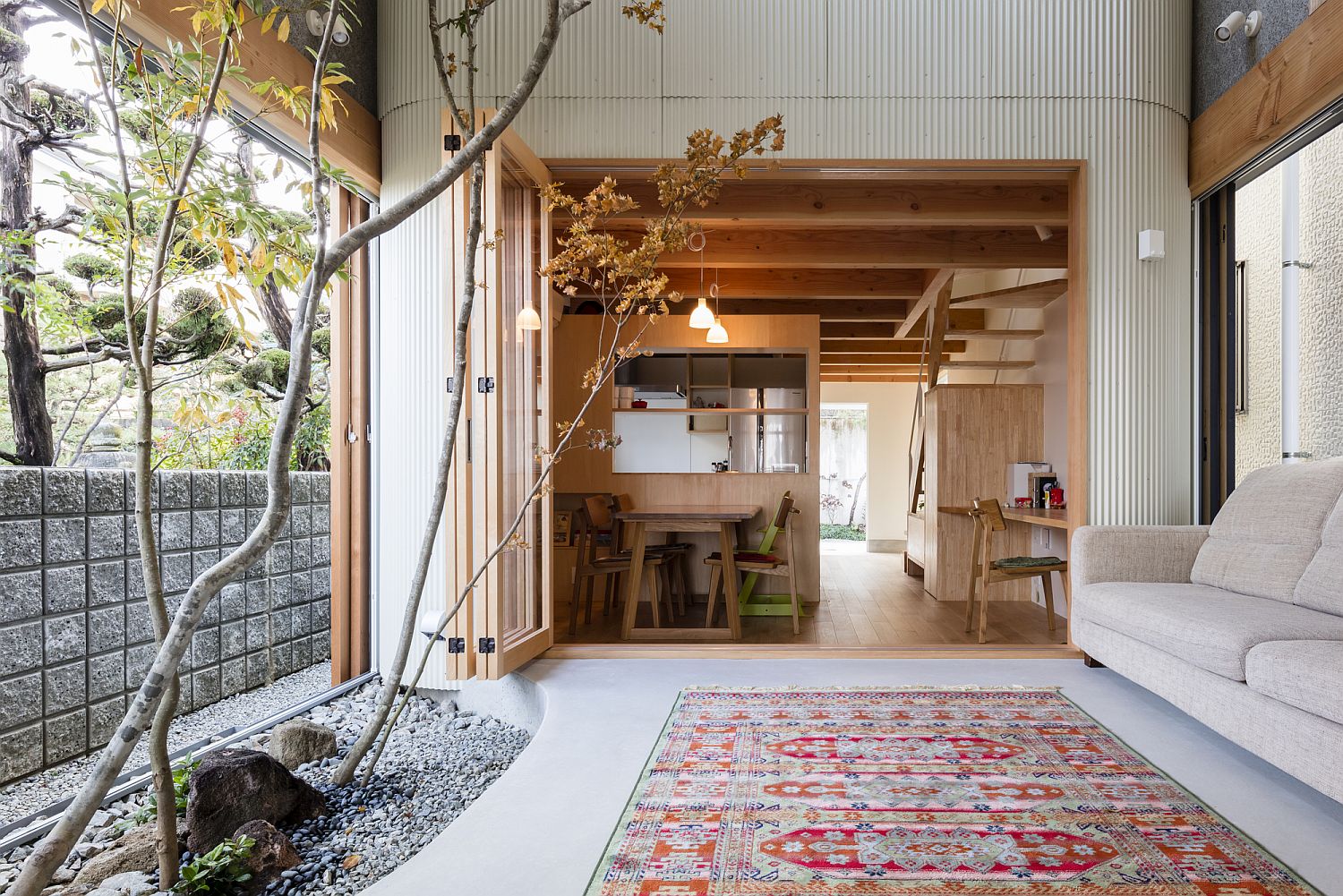 Covered indoor garden of the house separates the dining area from the living room