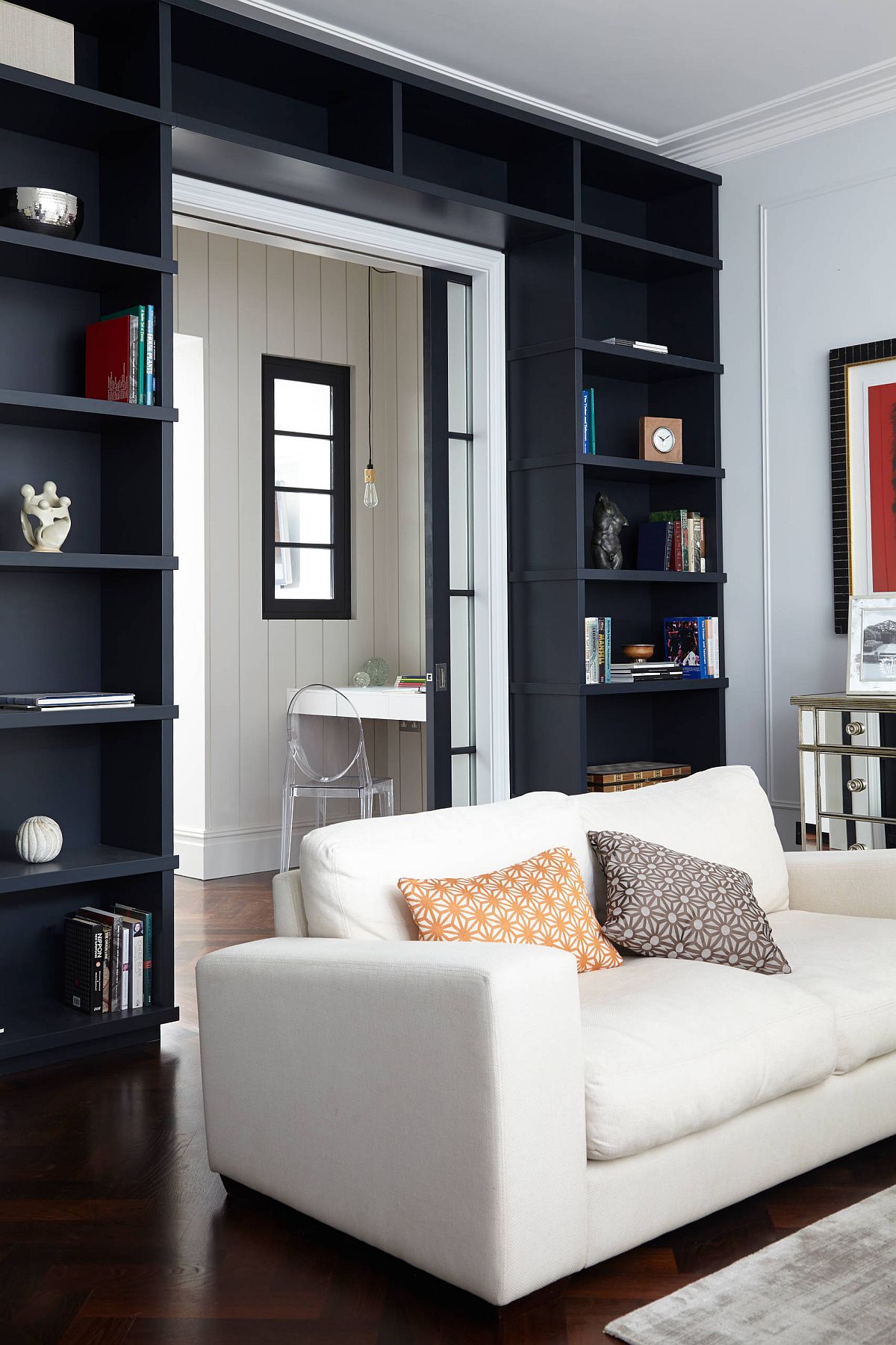 Dark-and-dashing-doorway-created-using-black-open-shelves-wrapped-around-it