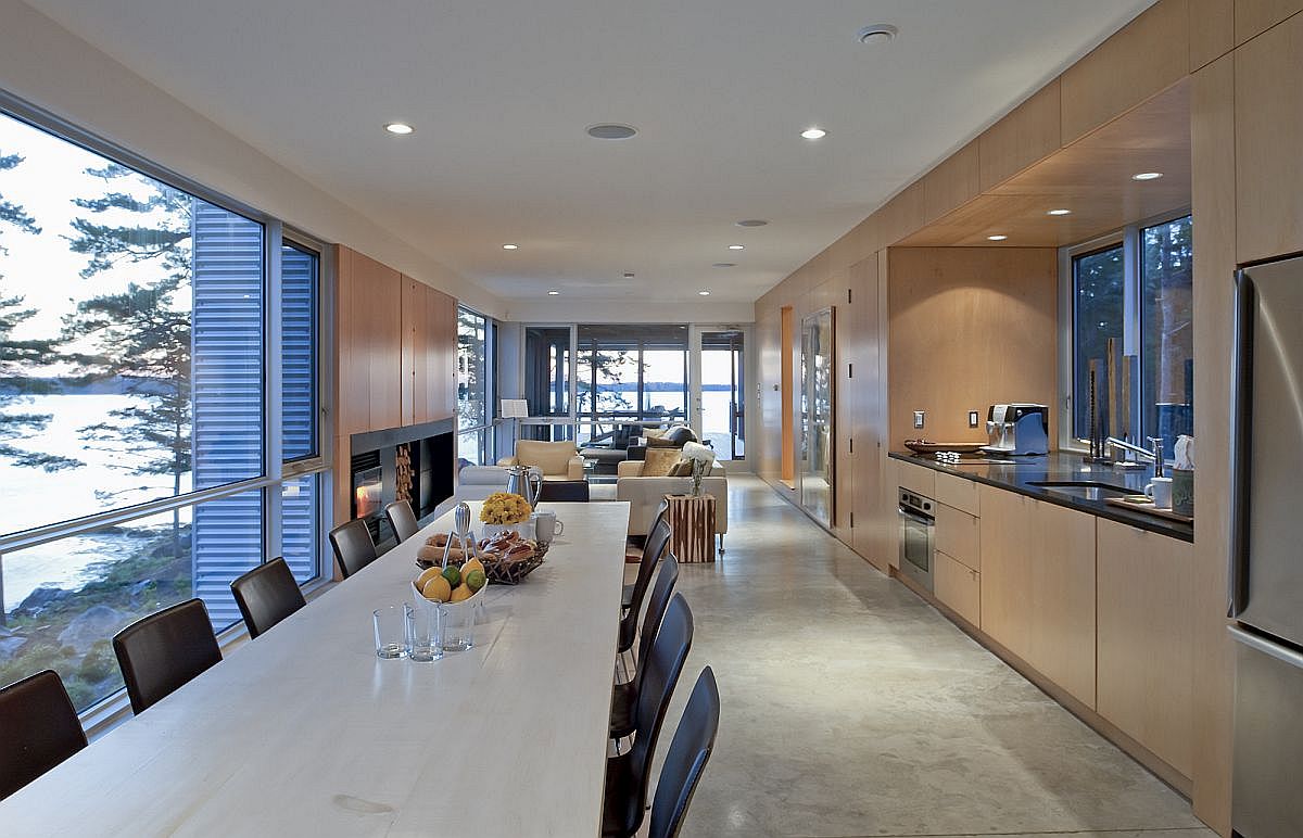 Dining space and kitchen of the smart contemporary home in Canada