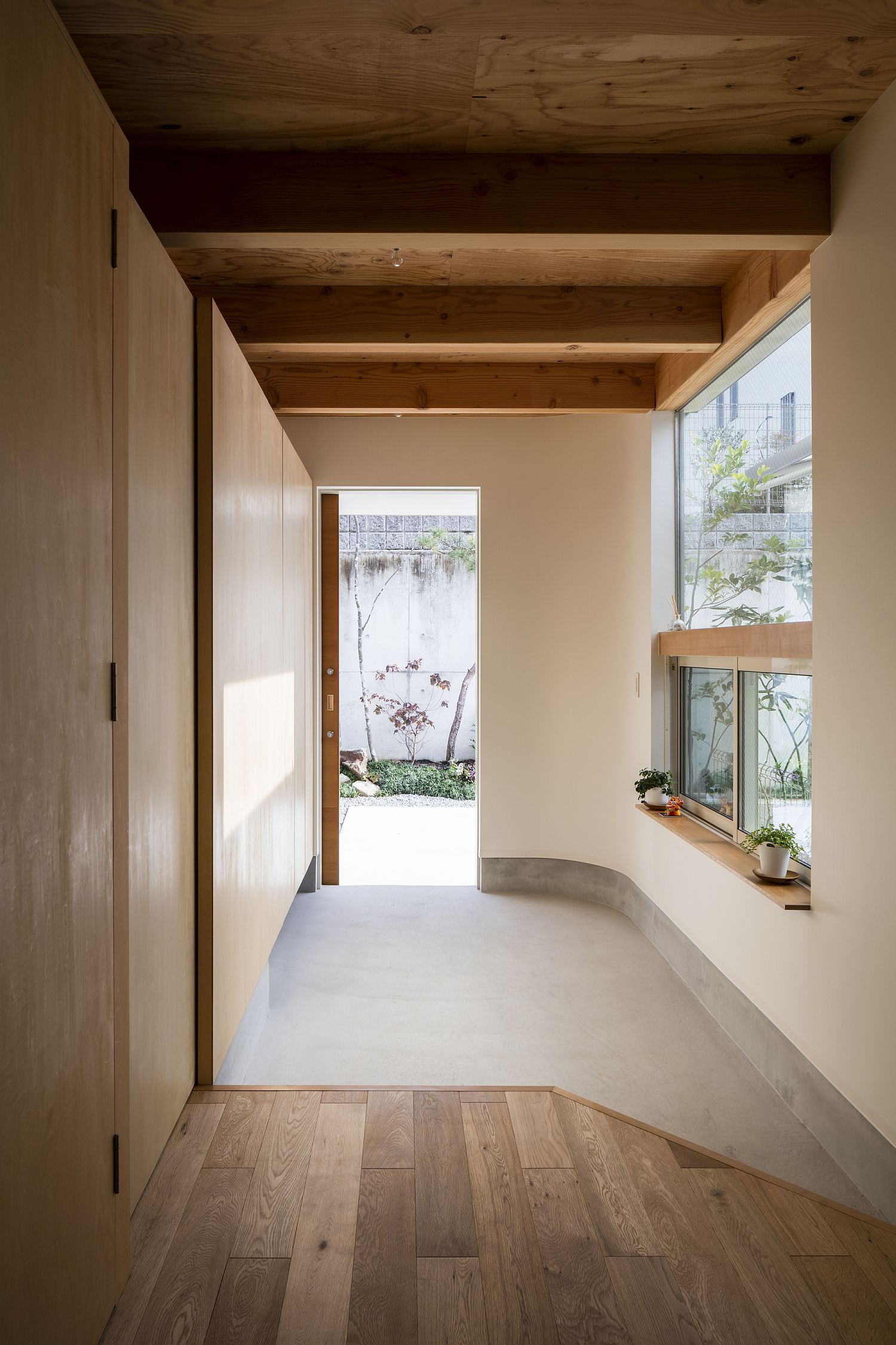 Entry and Japanese room welcome guests at this narrow home that is space-savvy and eco-friendly