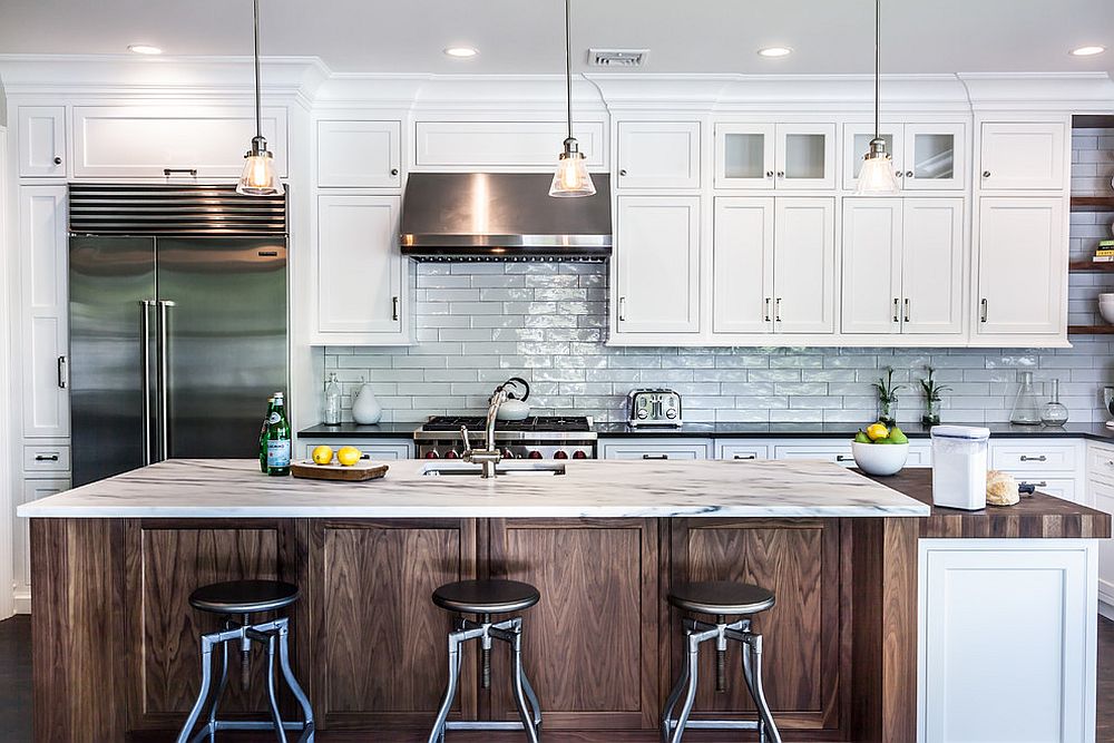 Exquiste kitchen of New York home with backdrop in white subway tiles and wooden island