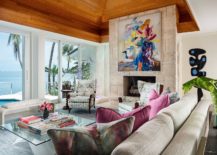 Fireplace-with-colorful-wall-art-sits-at-the-heart-of-the-breezy-tropical-living-room-of-Miami-Home-217x155