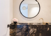 Floating-stone-vanity-in-the-small-and-light-filled-bathroom-of-Chicago-apartment-217x155