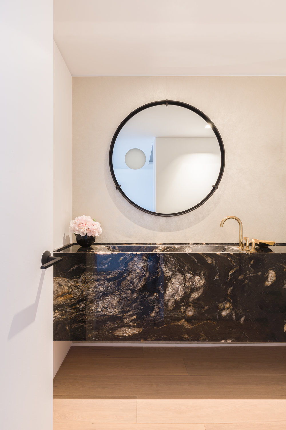 Floating-stone-vanity-in-the-small-and-light-filled-bathroom-of-Chicago-apartment