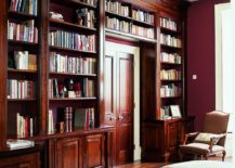French-walnut-shelves-around-the-doorway-along-with-red-walls-shape-a-classic-reading-room-217x155