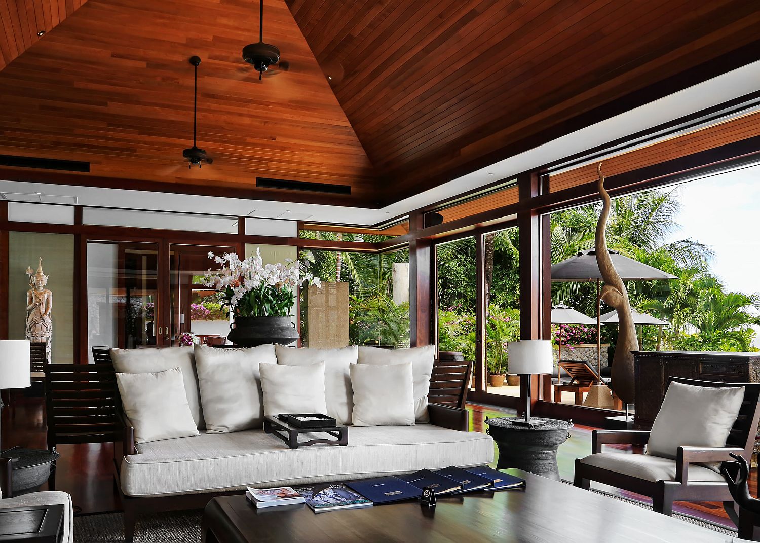 High ceiling in wood aling with ample natural light for the spacious tropical living room