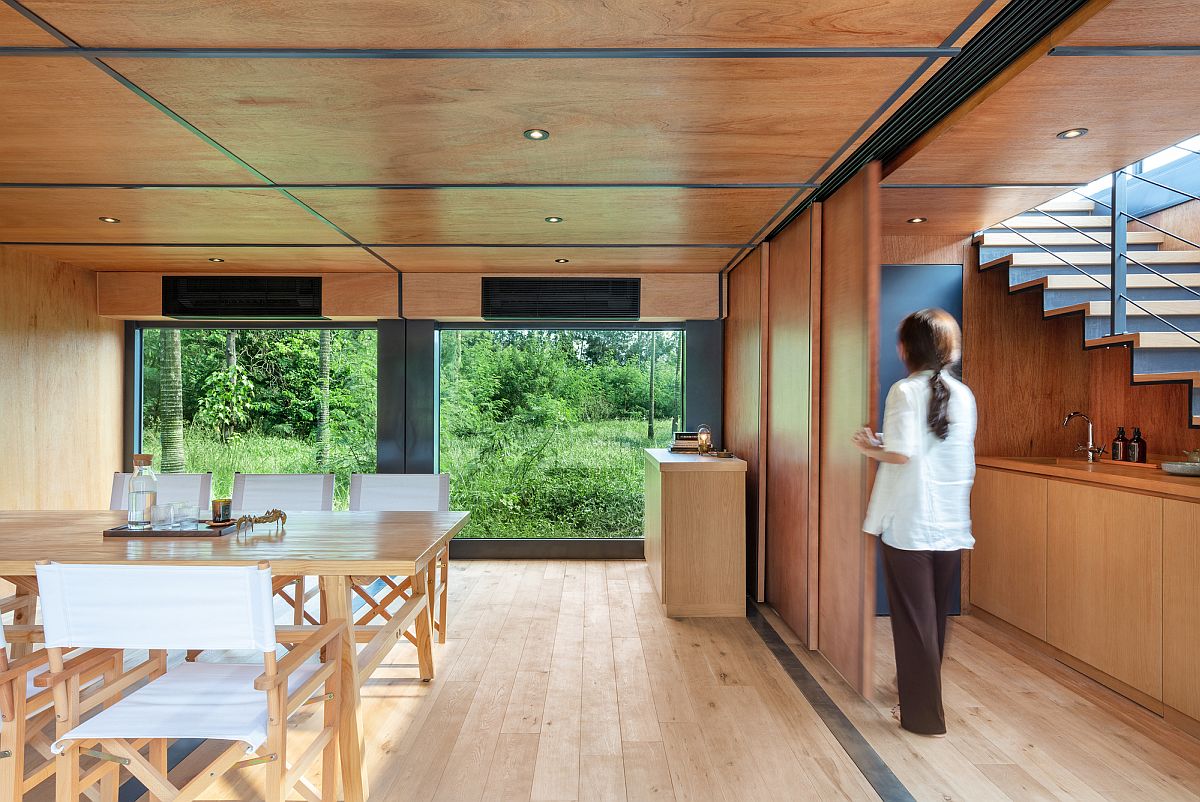 Lower-level-of-the-marketing-suite-with-dining-area-and-kitchen-draped-in-wood
