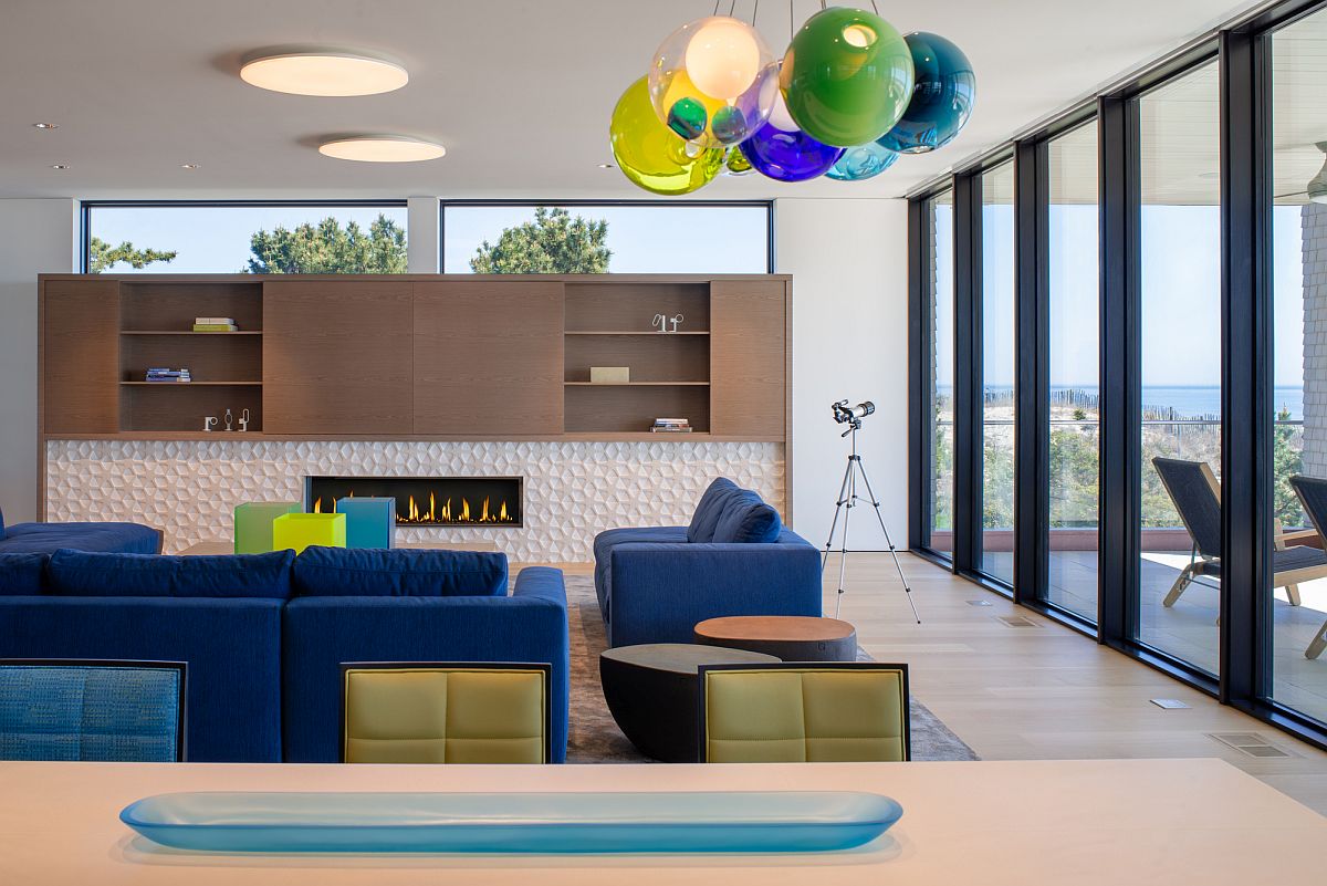 Multi-colored lighting fixtures and couch bring brightness to the living space