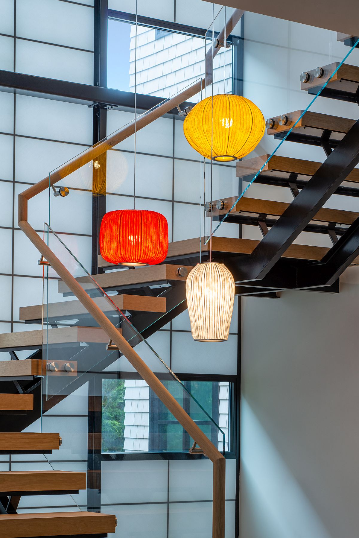 Multi-colored pendant lights for the staircase and its lightwell