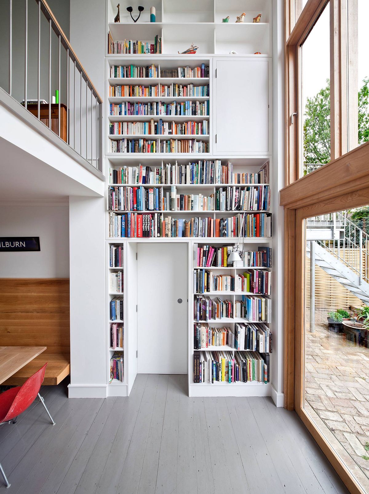 Multi-level living room library wall in white steals the show in this house