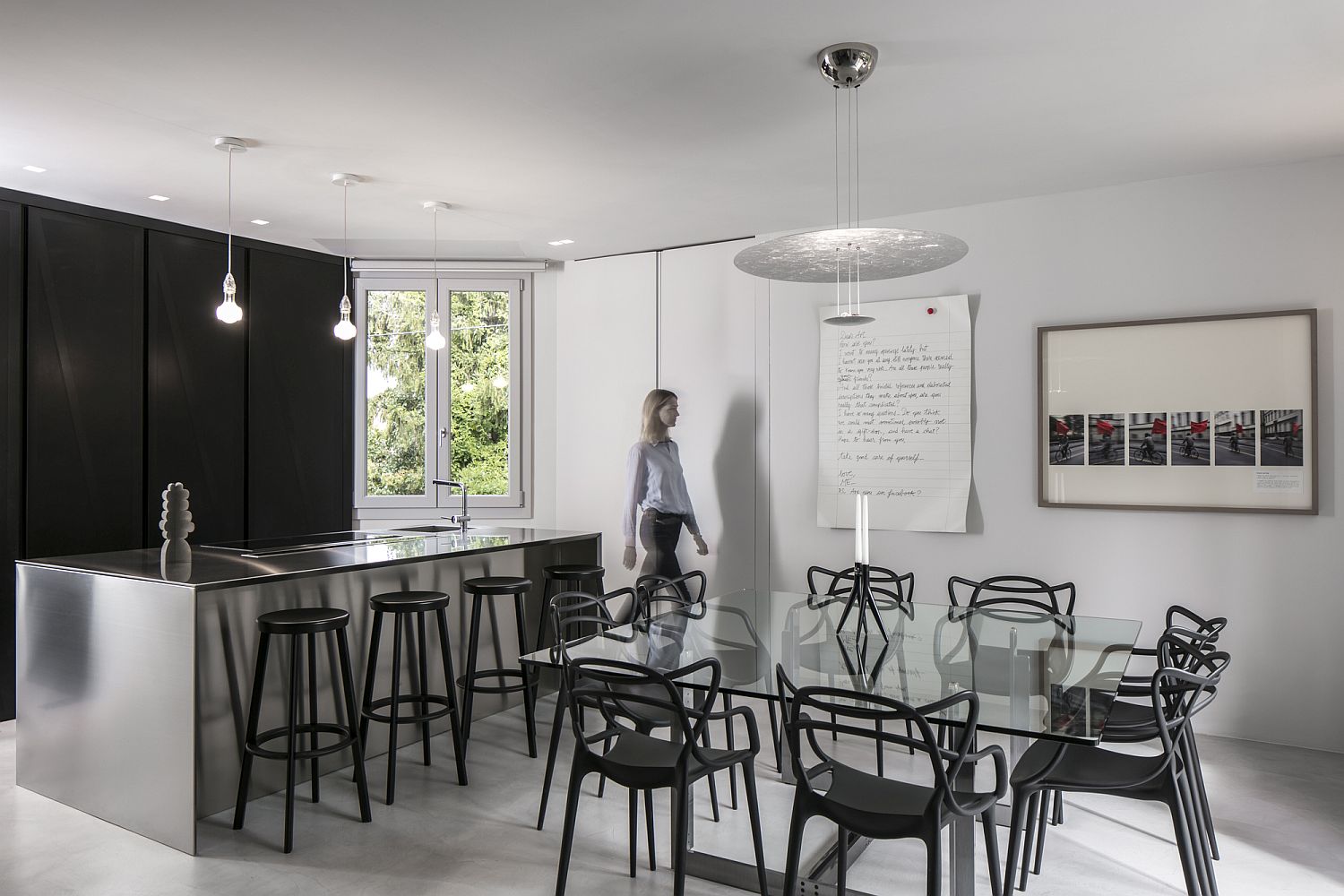 Open plan living area in shades of gray along with black accents