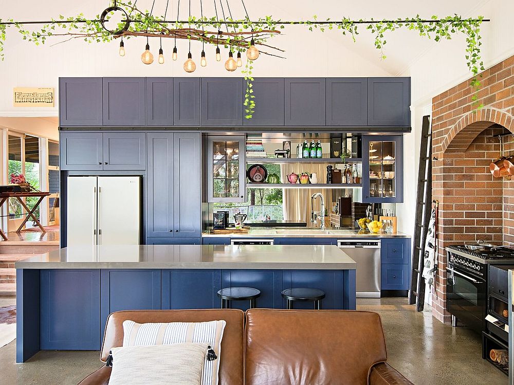 Shaker style cabinets in deep blue steal the show inside this eclectic gallery kitchen