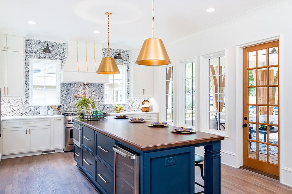 Transitional-kitchen-in-white-and-blue-with-bold-metallic-pendants