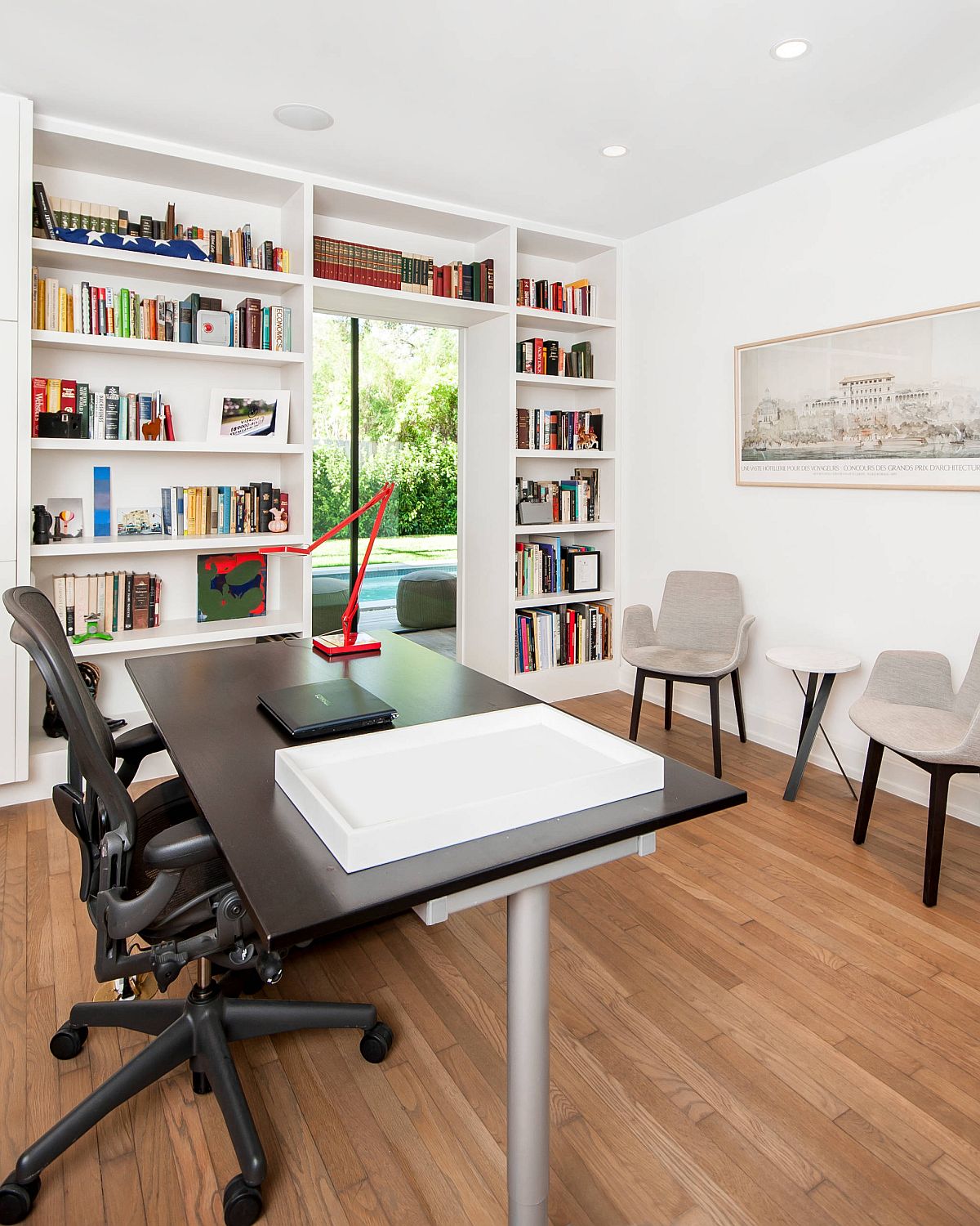 White-and-wood-home-office-with-bookshelf-wrapped-around-the-doorway