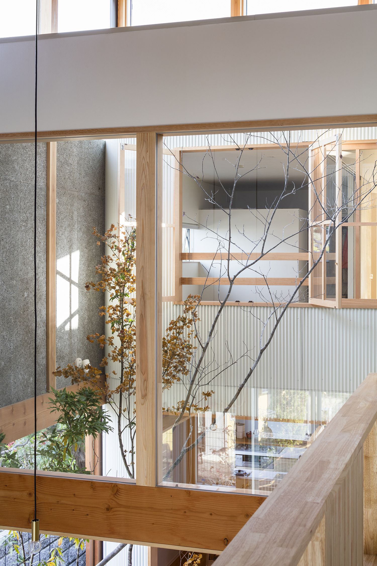 White, wood and glass create a cool interior inside the Japanese home