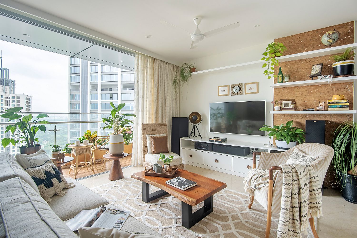 Wood and white apartment living room with relaxed tropical style and plenty of greenery