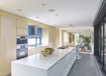 Wood-and-white-kitchen-of-the-house-with-sliding-glass-doors-that-usher-in-ample-light-217x155