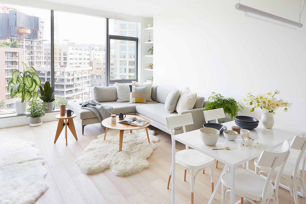 Apartment living room in white with sectional in the corner