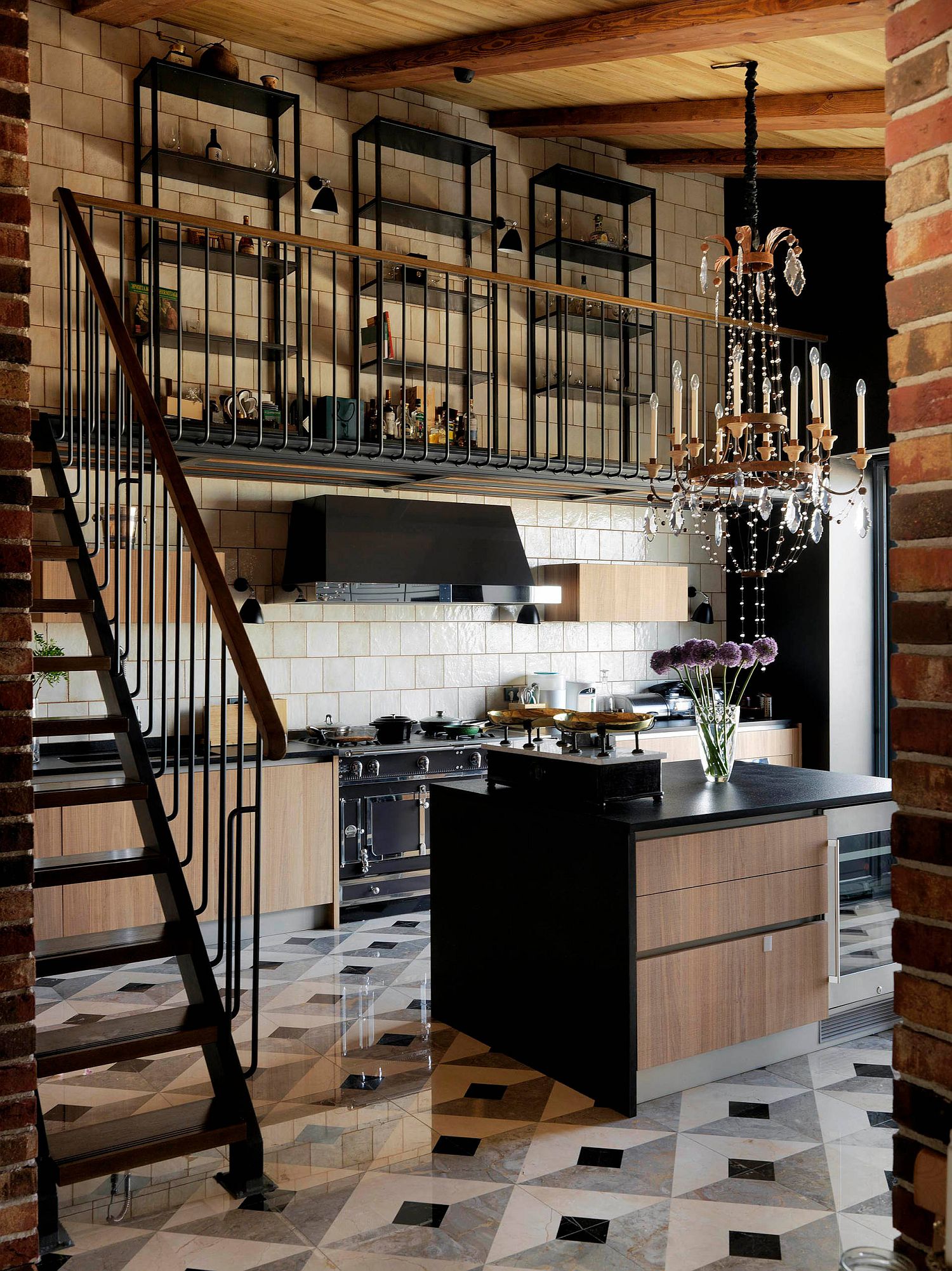 Beautiful industrial style kitchen full of textural contrast, black appliances and dark countertops