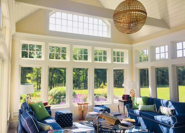 Beautiful Influx Of Blue In The Spacious And Traditional Sunroom Of Boston Home Using Couch And Club Chairs 83767 650x467 