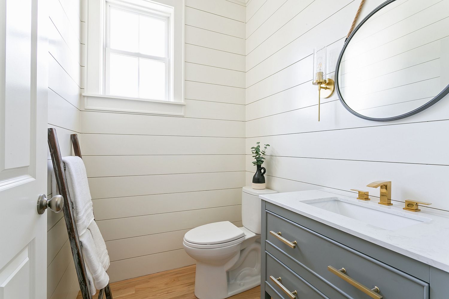 Beautiful white and gray powder room with smart, even lighting