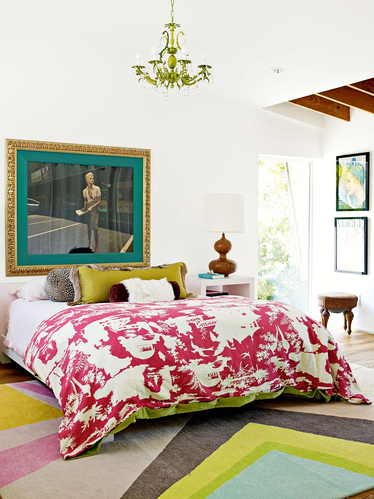 Bedding, rug and accent pillows add color to the eclectic neutral bedroom