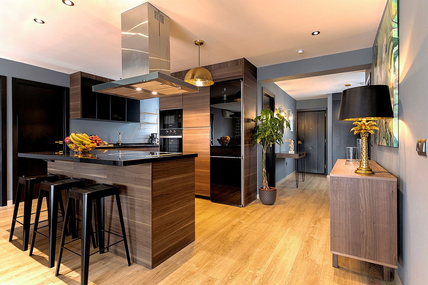 Black appliances add gloss and class to the contemporary kitchen in wood and white