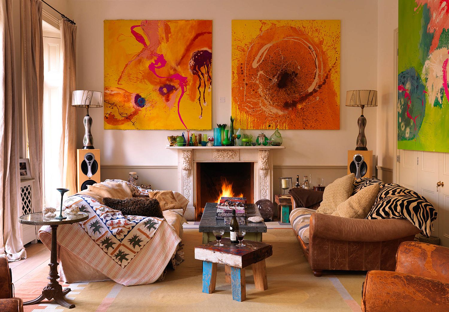 Blend of fabrics, bright wall art and a cozy fireplace come together to create this fabulous living space