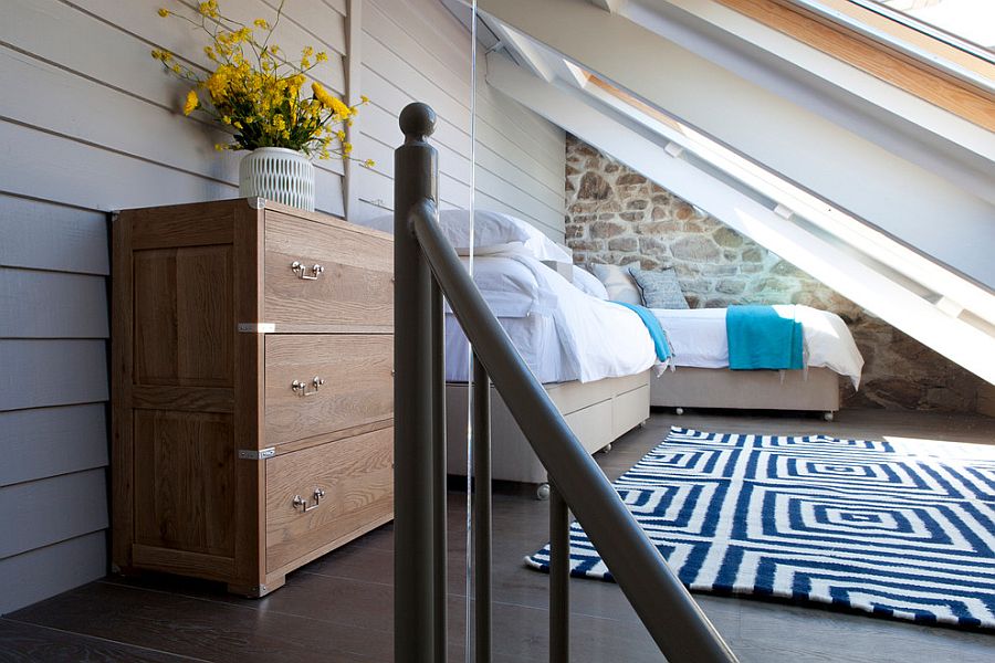 Blue and white work just great in the tiny attic bedroom with beach style