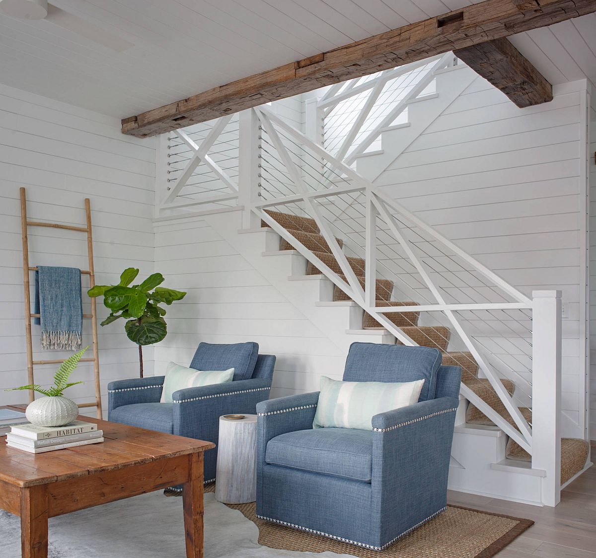 Blue chairs add color to the tiny white living room