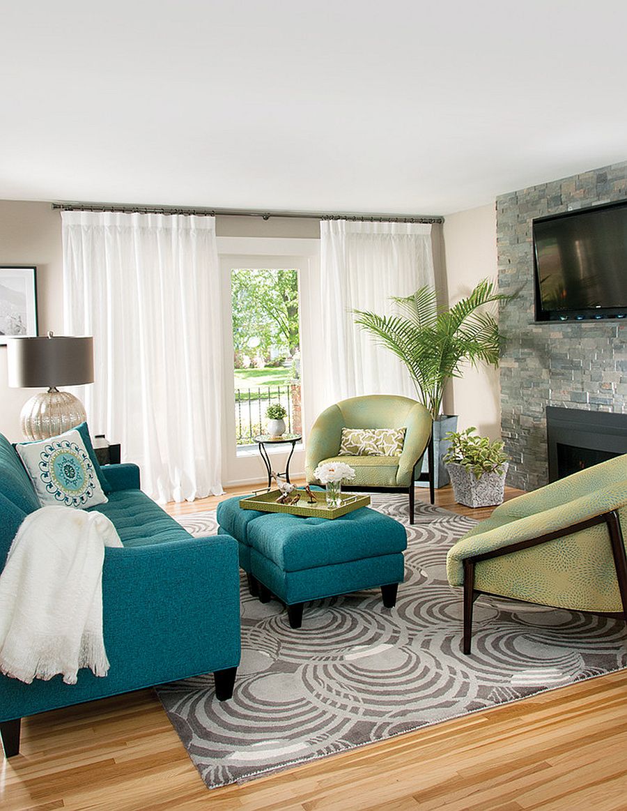 Blue couch and light green club chairs enliven the white living room