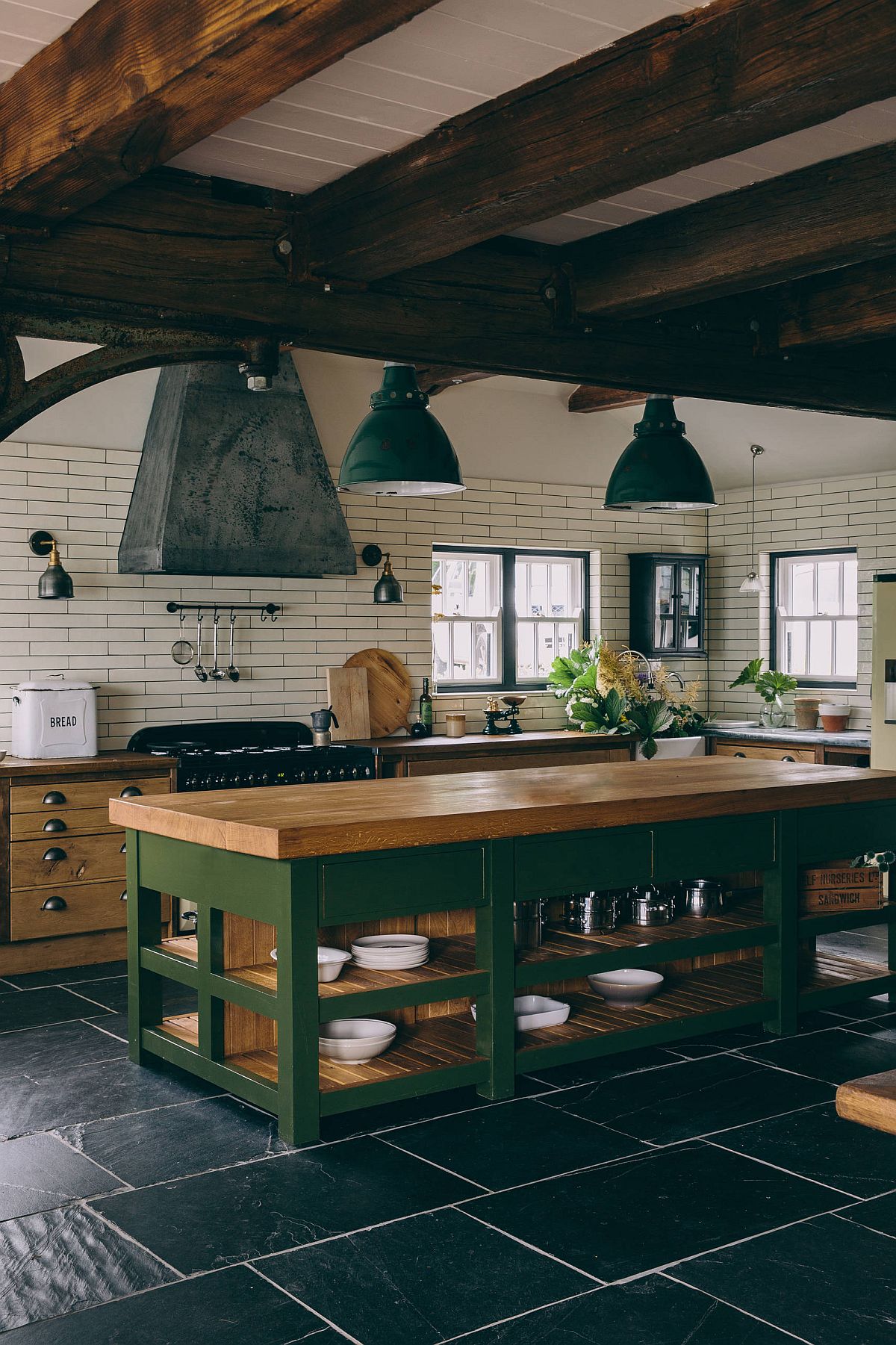 Brilliant use of green in the rustic kitchen with wooden countertops and ceiling beams