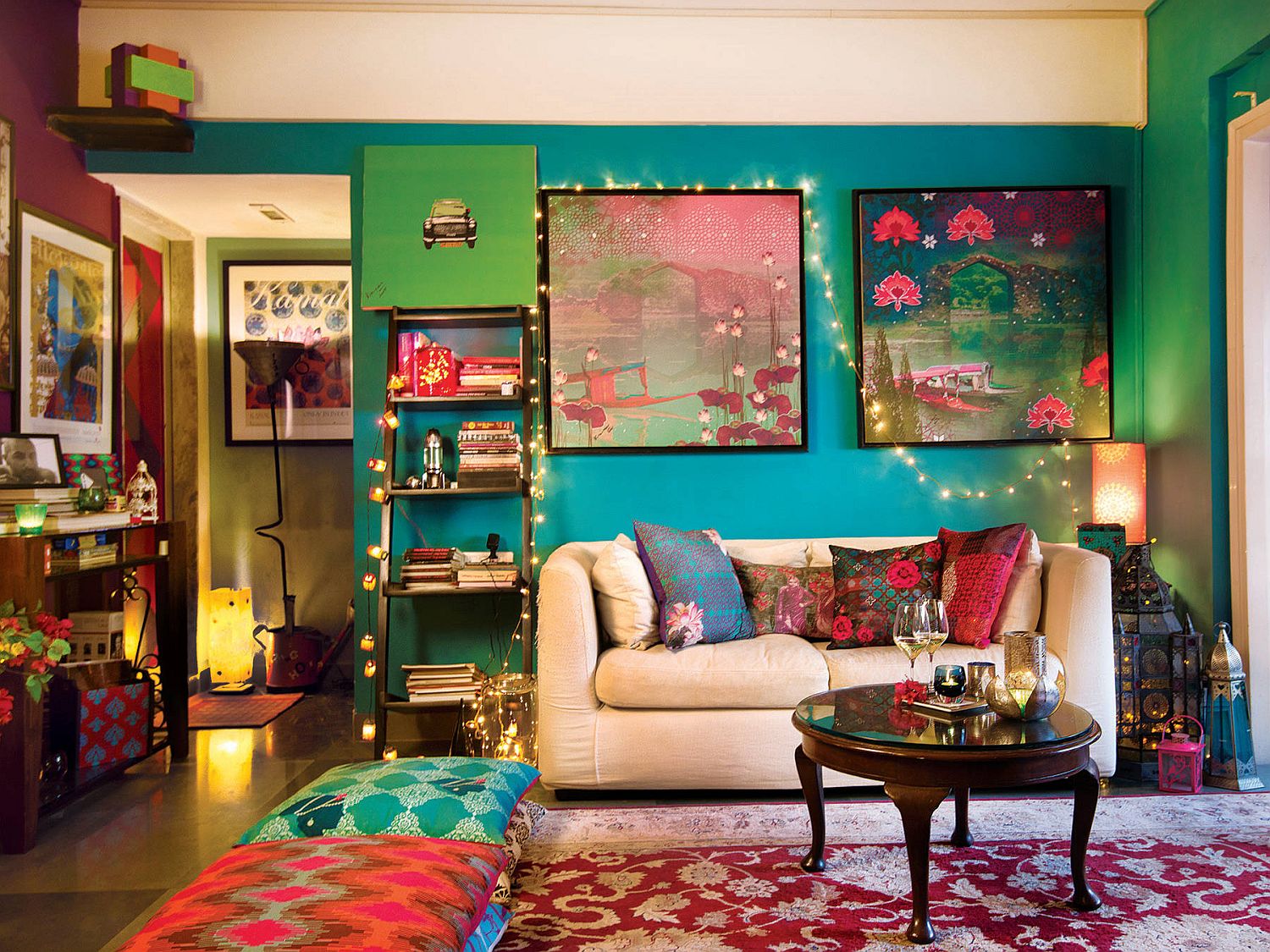 Color-filled eclectic living room illuminated by string lights is more boho than it is chic!