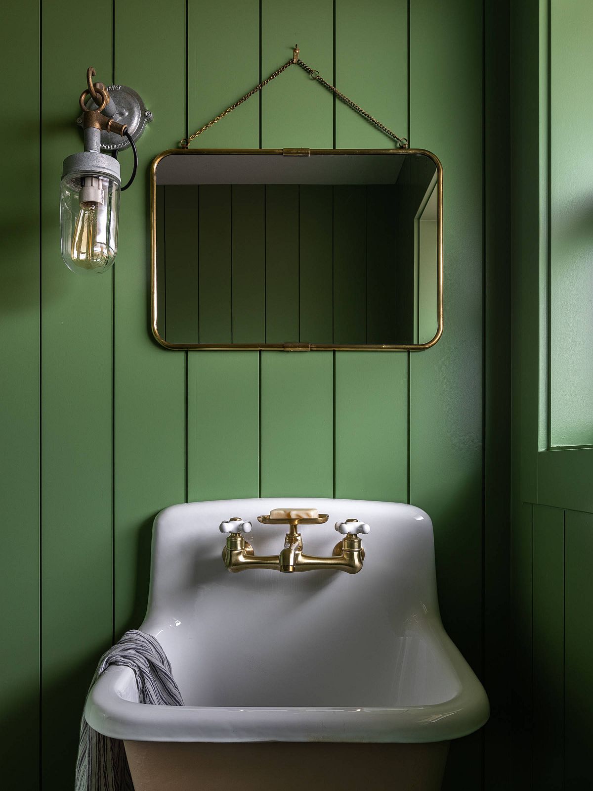 Cottage-style powder room with fabulous green walls and white sink