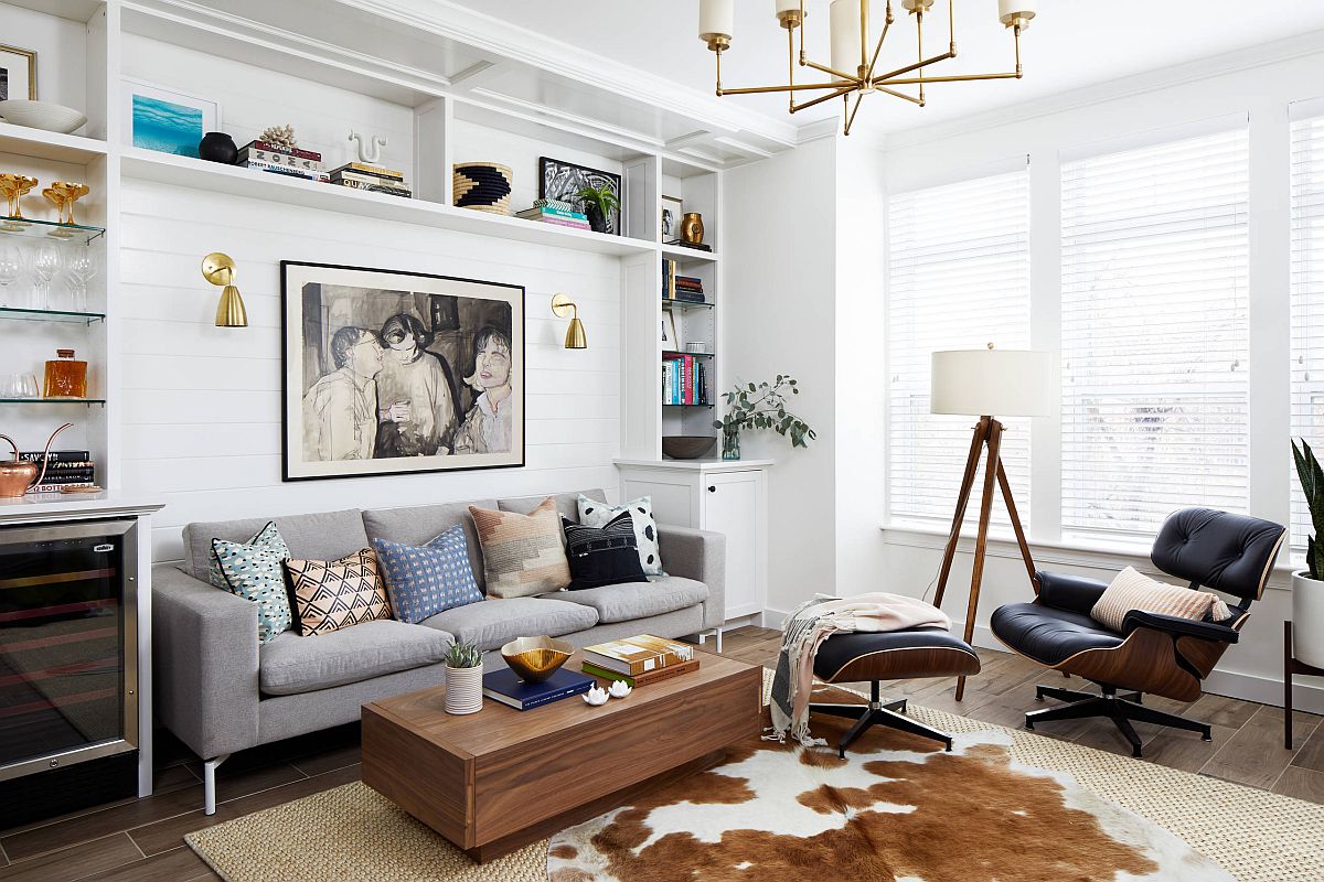 Cowhide rug and metallic accents bring brightness to the light-filled living room