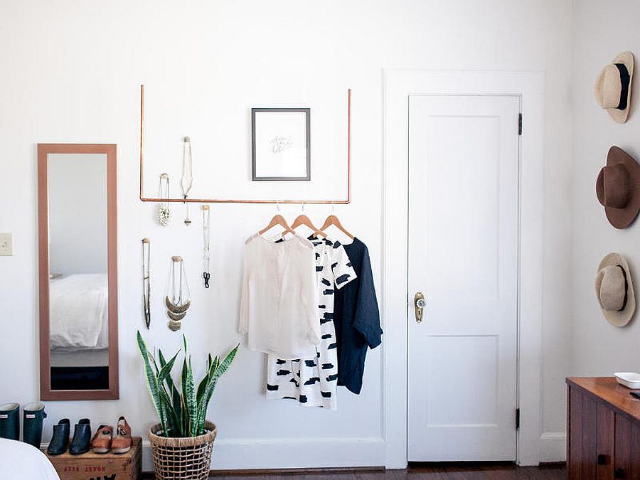 Crates, copper pipes and other DIY creations replace the traditional closet in this tiny bedroom