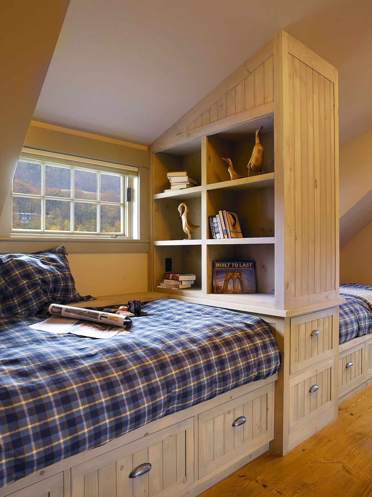 Custom space-savvy attic bedroom design with wooden cabinets and ample storage space