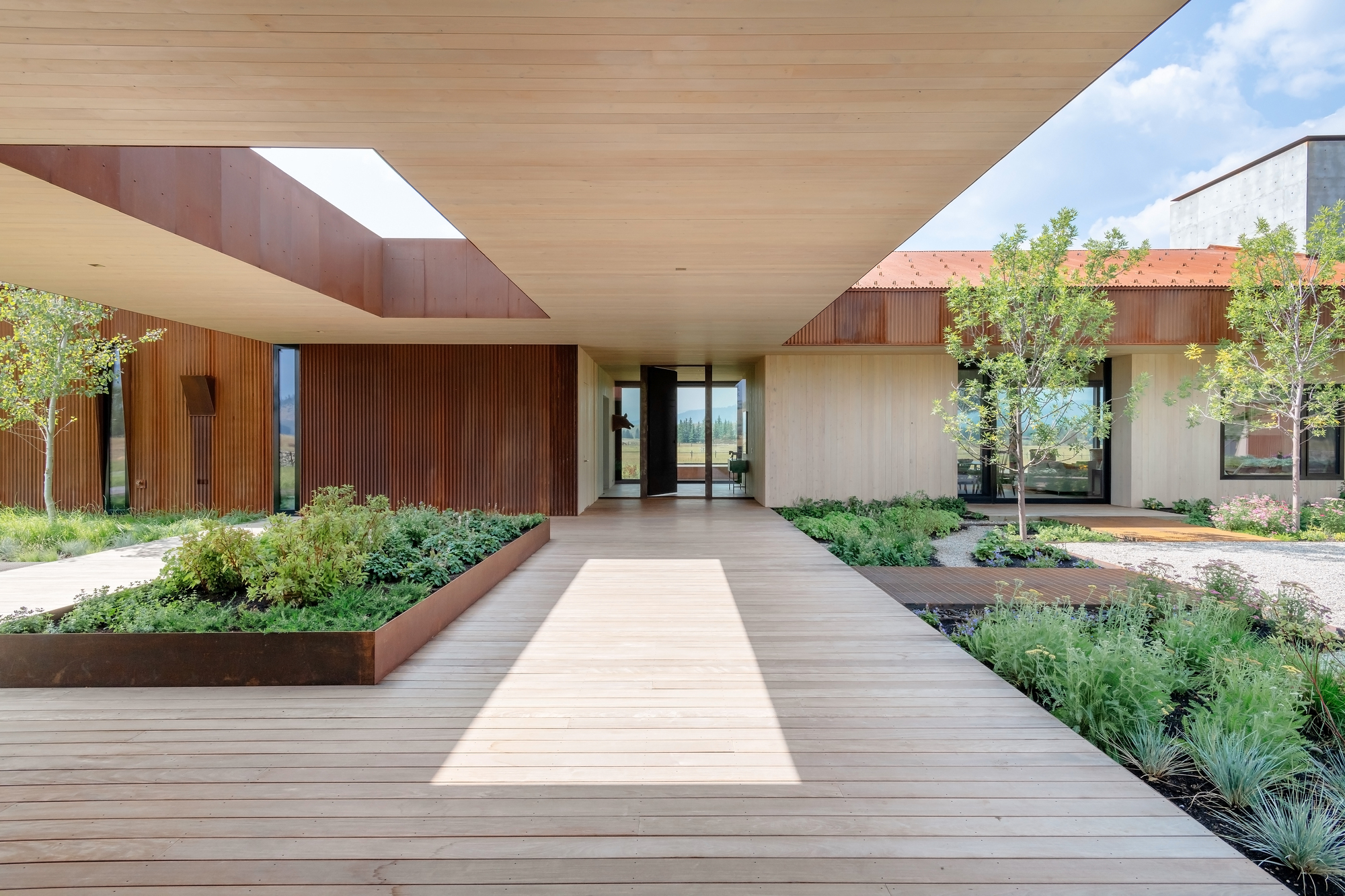 Extended sections of the house and its dogtrot gabled form provides shaded walkways around the house