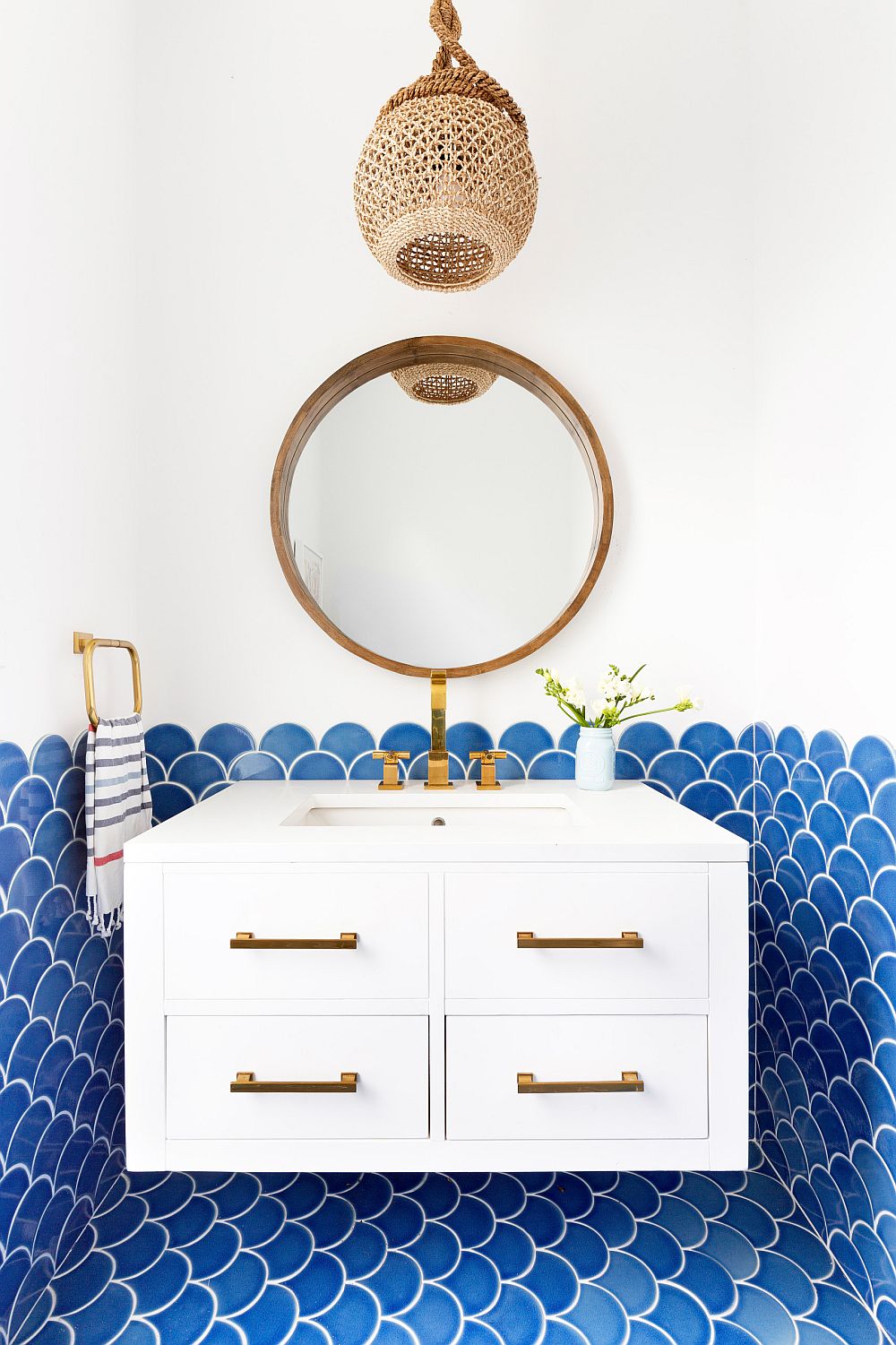 Fish scale tile in blue for the tylish beach style powder room in white